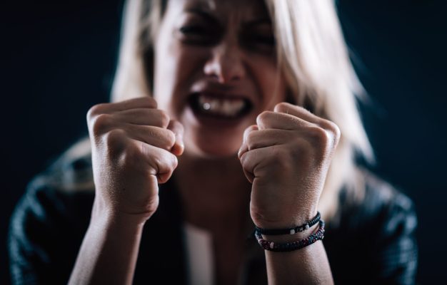 Aggression – Portrait of an Angry Aggressive Woman with Clenched Fists Aggression – portrait of an angry aggressive woman with clenched fists