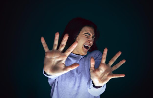 close-up-portrait-young-crazy-scared-shocked-woman-isolated-dark