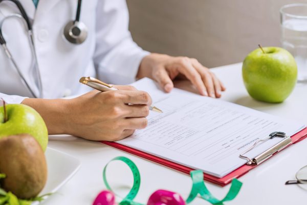 Nutritionist giving consultation to patient with healthy fruit and vegetable, Right nutrition and diet concept Nutritionist giving consultation to patient with healthy fruit and vegetable, Right nutrition and diet concept